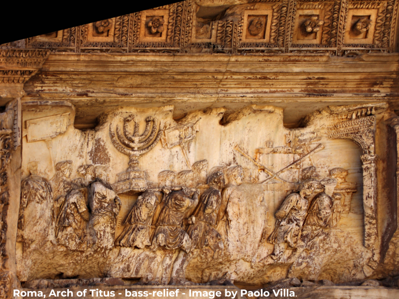 A photograph capturing the Arch of Titus in Rome, a monument built in 81 AD to commemorate the Roman victory in the Jewish-Roman War. On the bas-reliefs of the arch, one can observe the depiction of a menorah, taken as war spoils from the Temple in Jerusalem. The image symbolizes the conquest and destruction of the Second Temple, as well as the spiritual resilience of the Jewish people.